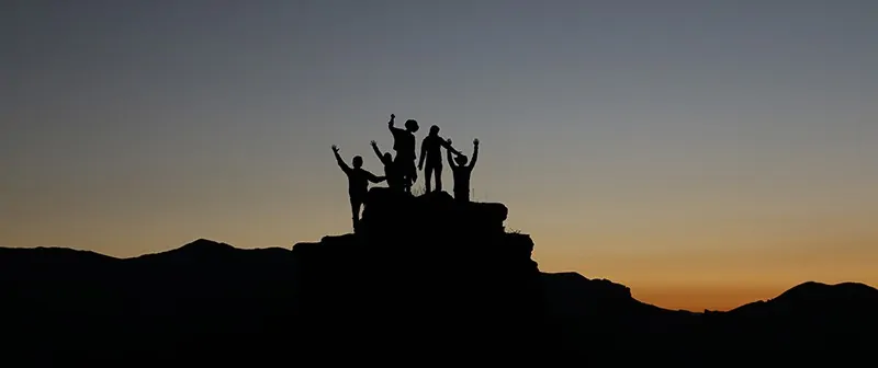 Image of a group of people summiting a mountain