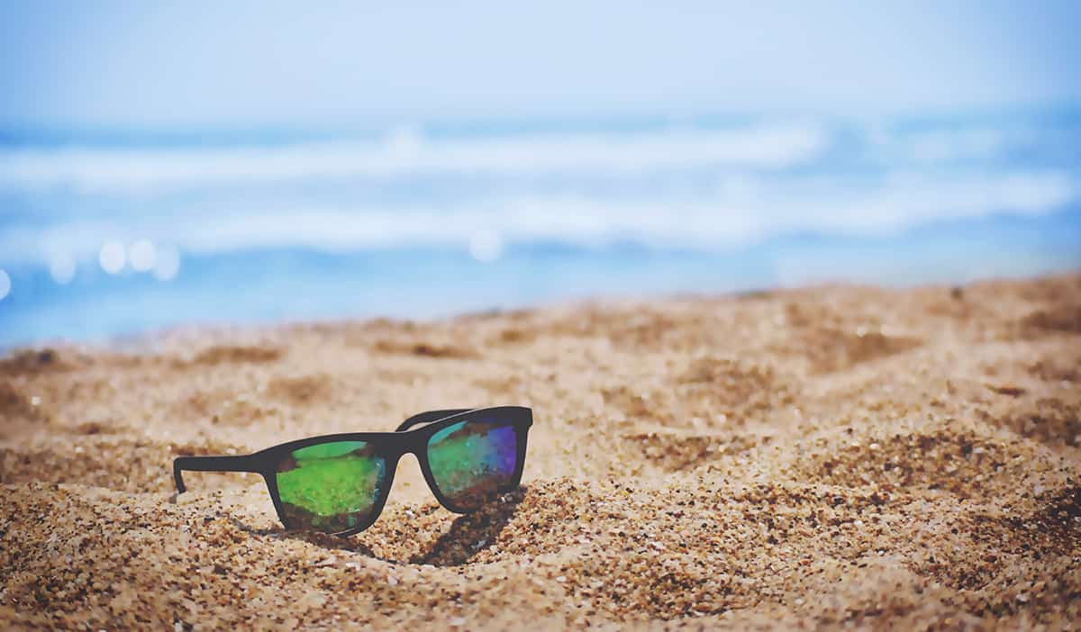 Image of sunglasses on a beach during summer