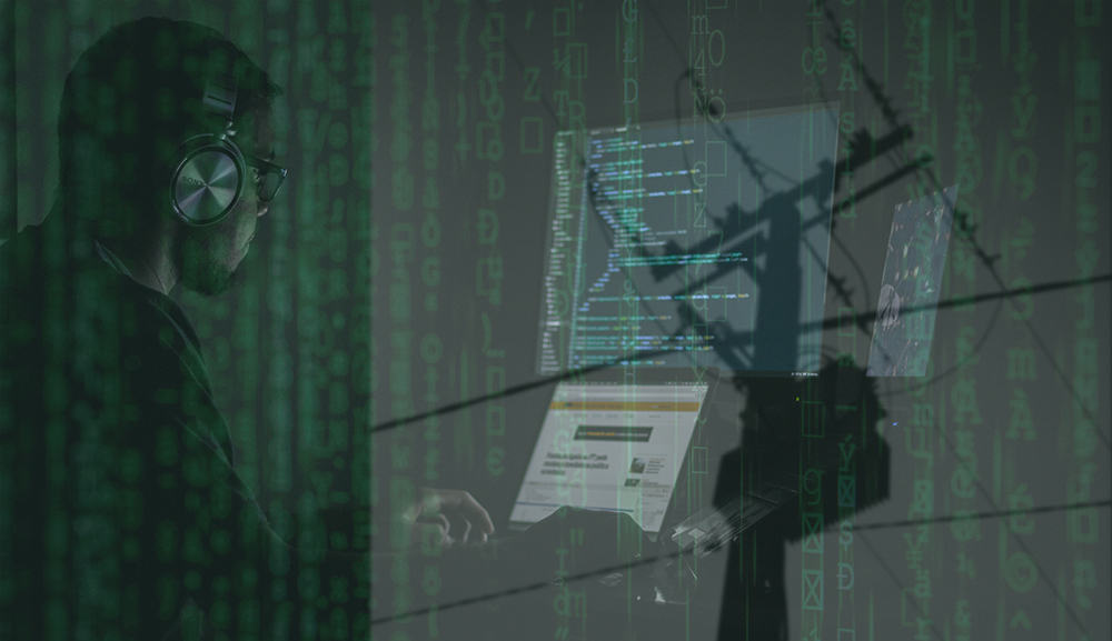 Image showing a man coding overlayed with matrix code and a electrical pole