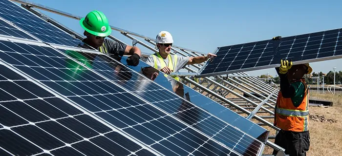 An image of workers installing solar energy panels